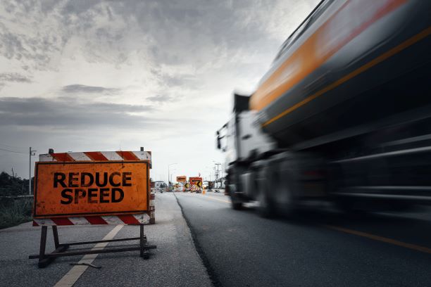 High-Speed Truck with "Reduce Speed" Sign